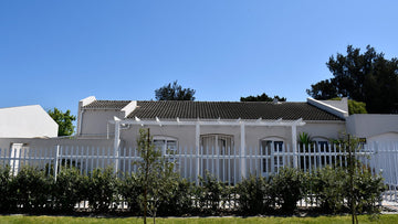 White palisade fence in front of house