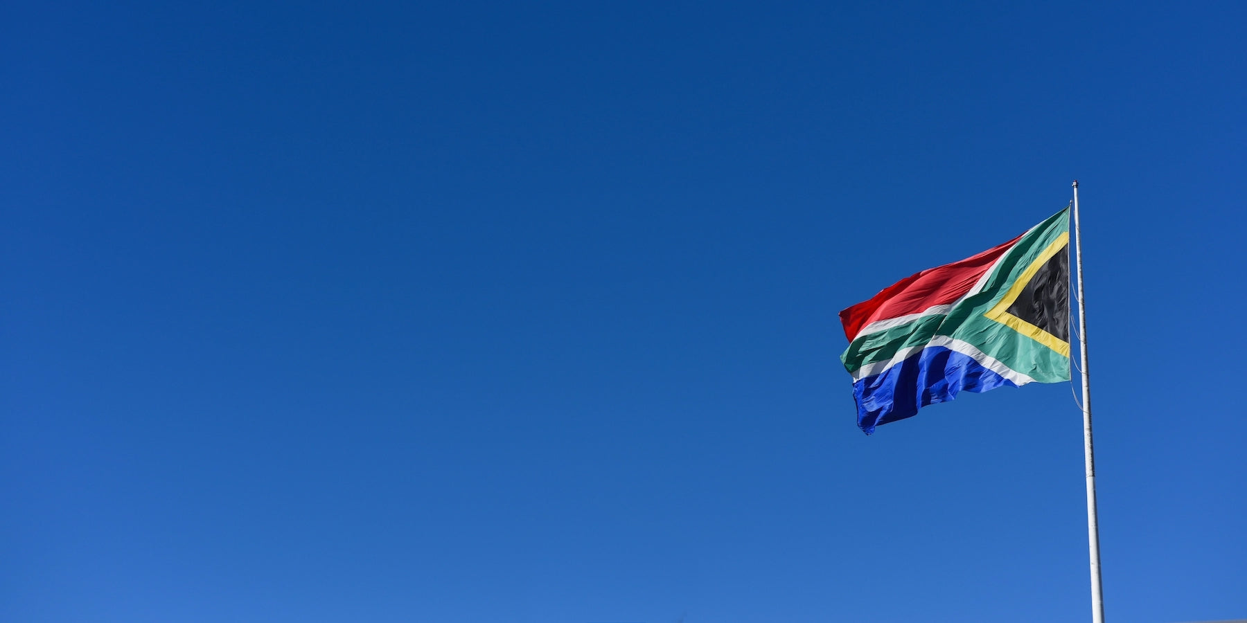Blue sky with South African flag flying