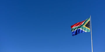 Blue sky with South African flag flying