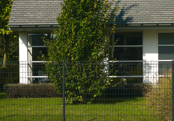 Metal Fence in front of white building